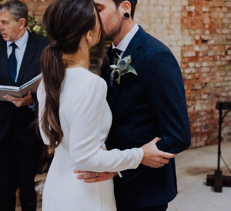 Bride and groom share their first kiss as a married couple