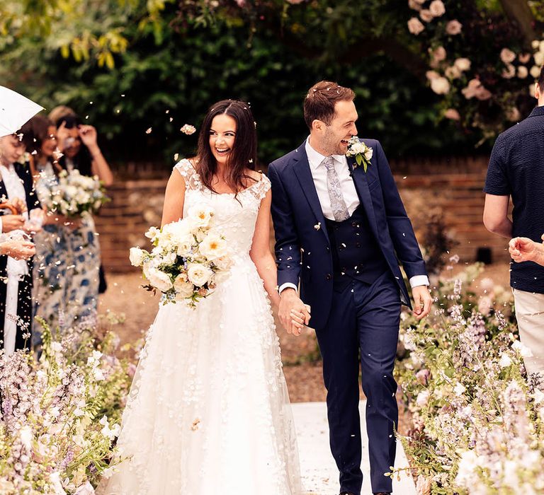 Bride and groom have a confetti exit from their ceremony 