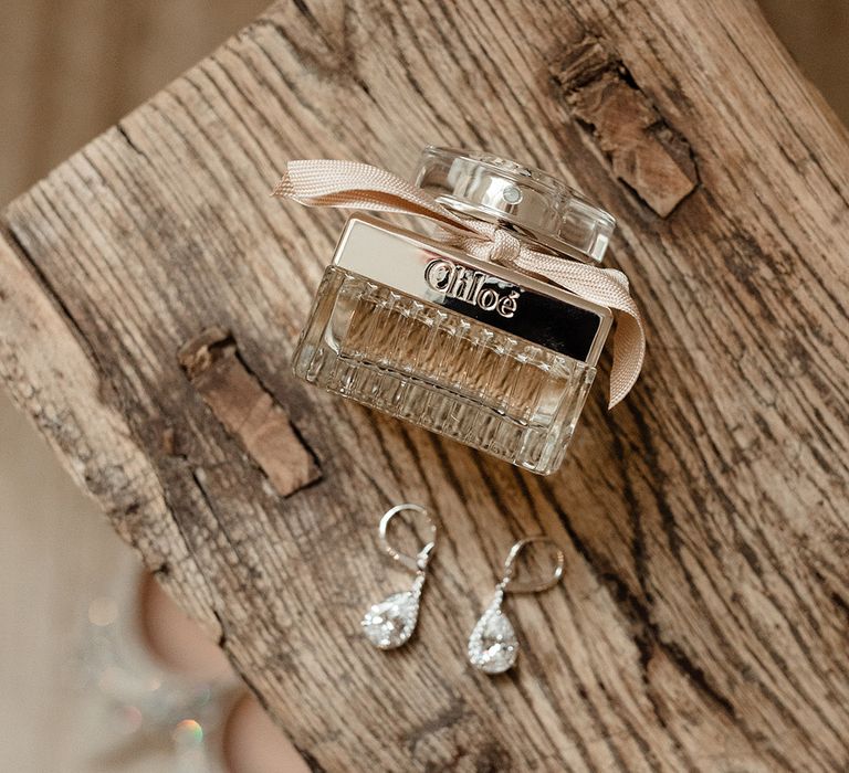 Chloe perfume for the bride with diamond pear shaped earrings for the bridal accessories 