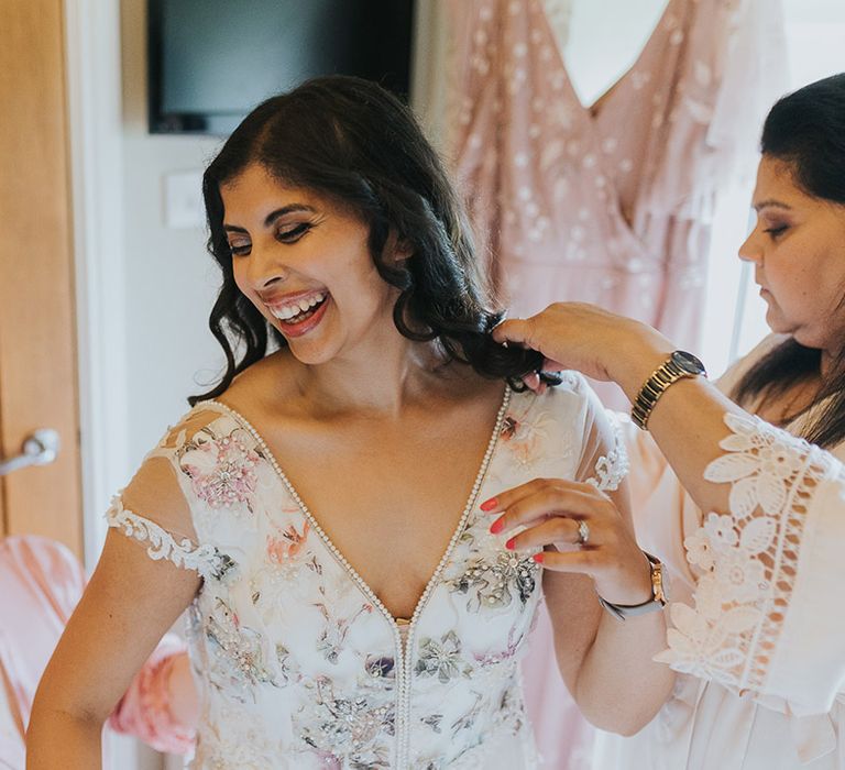 wedding morning bridal preparations with Indian bride in a floral Savin London Amelia wedding dress