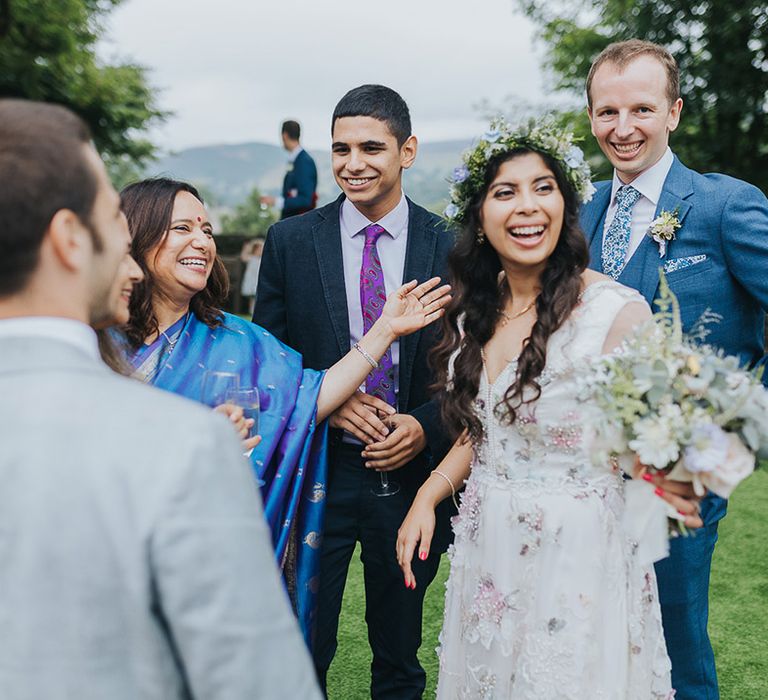 British Indian bride in a Savin London Amelia Dress with her groom in a light blue suit 