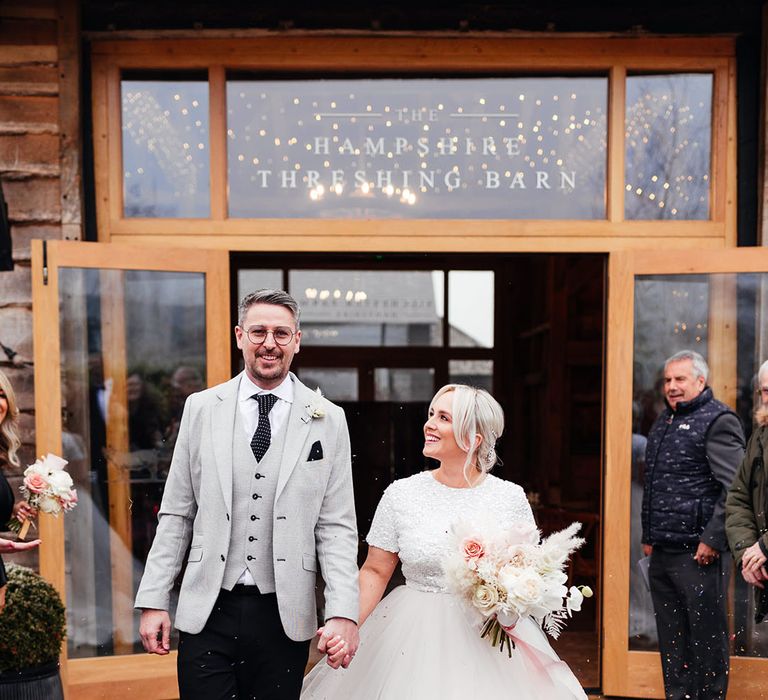 Silchester Farm winter wedding with the bride and groom walking out of their ceremony to confetti 