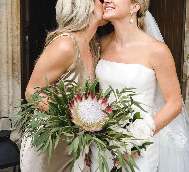 Bridesmaid holding King Proteas bouquet to represent the country where the bride and groom got engaged 