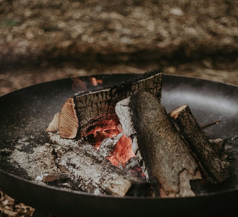 Outdoor fire pit at woodland wedding 