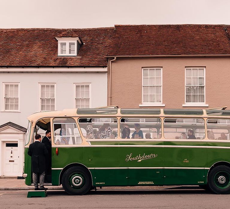 Green and cream wedding bus transport for wedding guests to get to the mansion wedding reception 