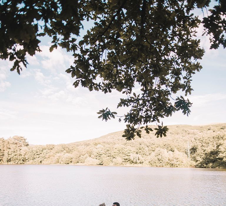 The bride and groom ride around on a wooden boat on their wedding day