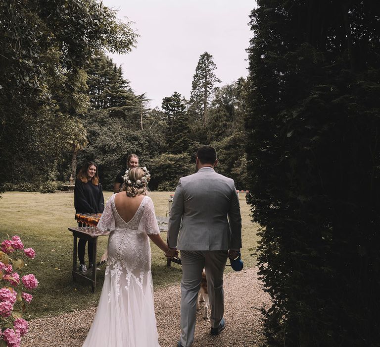 Bride in boho lace quarter length sleeve gown with wildflower wedding crown 