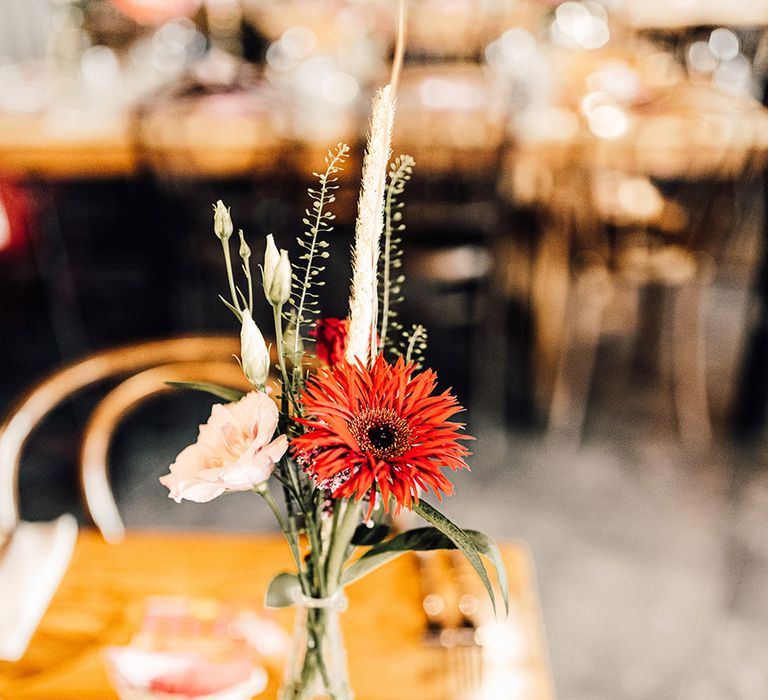 red wedding flower stem in a bottle wedding table decoration