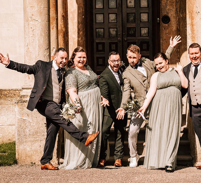 Wedding party wearing green theme wedding outfits with classic green and white wedding flower and buttonhole 