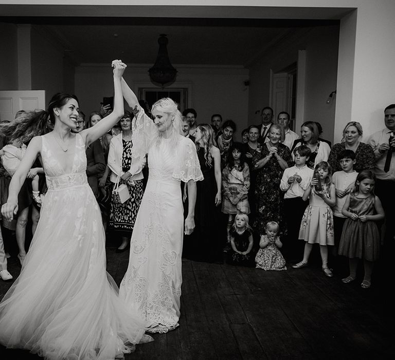 Brides have their first dance together captured in black and white wedding photo 