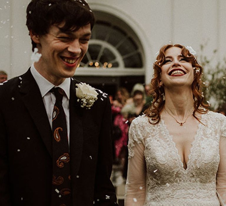 Groom in black suit with paisley patterned tie for dark autumn wedding 