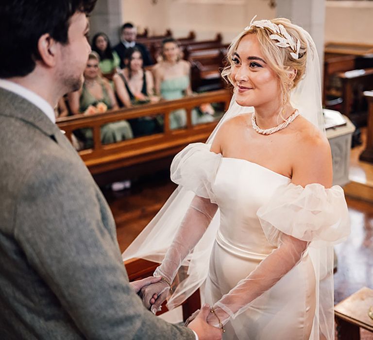 The bride and groom have their traditional church wedding ceremony with tropical wedding flowers 