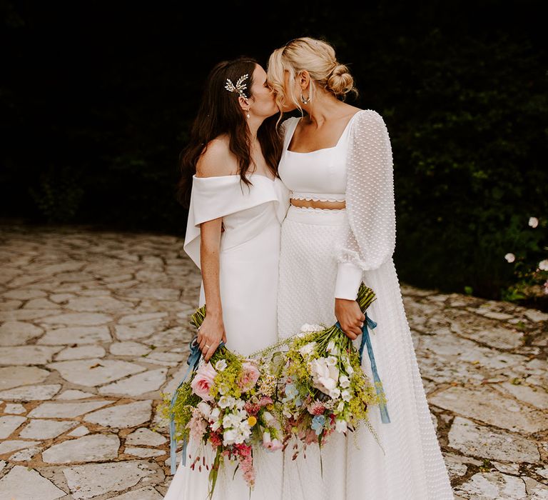 Lesbian wedding with same sex couple posing for romantic couple portrait 