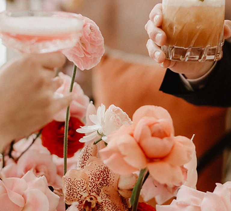 Pink and peach wedding tablescape with matching cocktails 