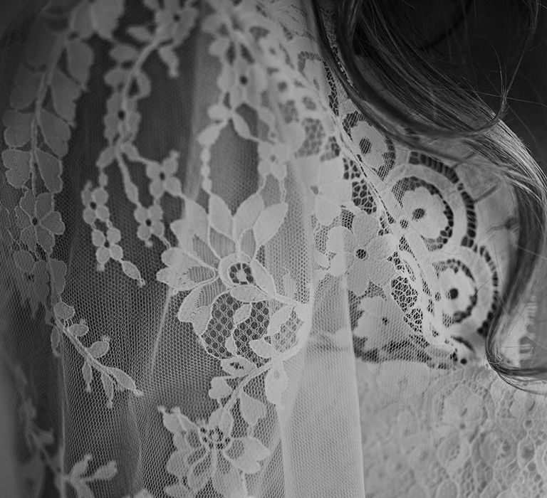 Delicate lace detailing on wedding dress with long sleeves 