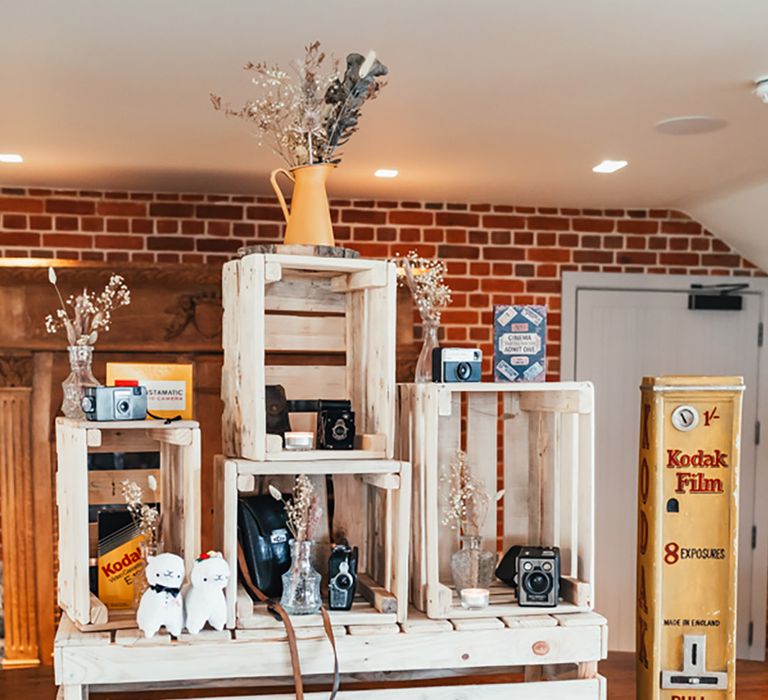 Rustic wedding decorations with wooden crates for the photobooth props and guest book 