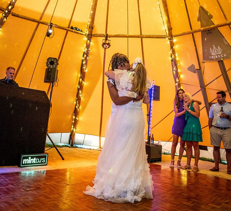 First dance for the two brides at their lesbian LGBTQI+ wedding in the tipi 