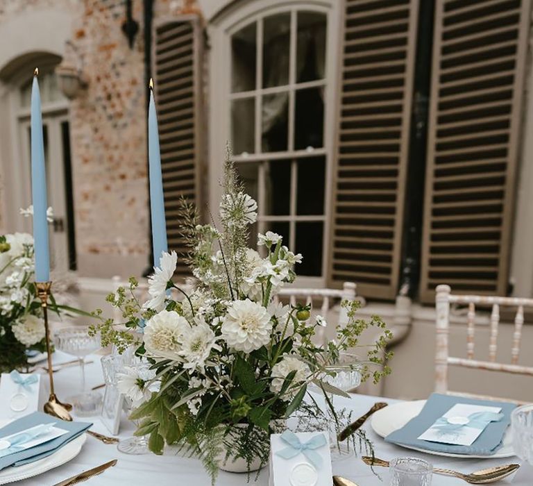 Blue bow wedding place names with blue napkins and wedding menus for the place setting 