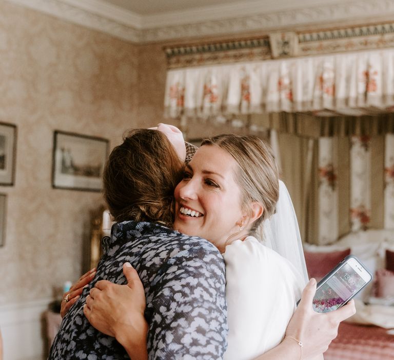 Bride hugs wedding guest at Pylewell Park wedding