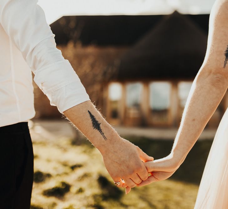 Couple on their wedding day with matching tattoos 