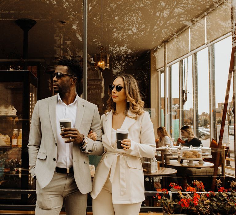 Stylish bride and groom celebrating their Portsmouth Guidhall city elopement with a coffee at their favourite cafe