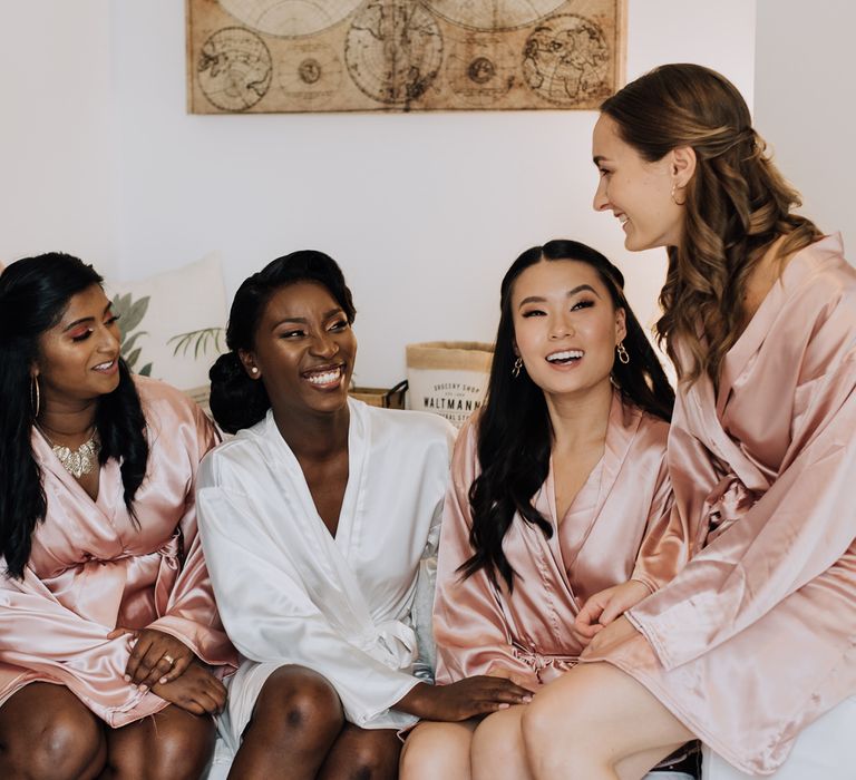 Bride and bridesmaids in satin getting ready robes