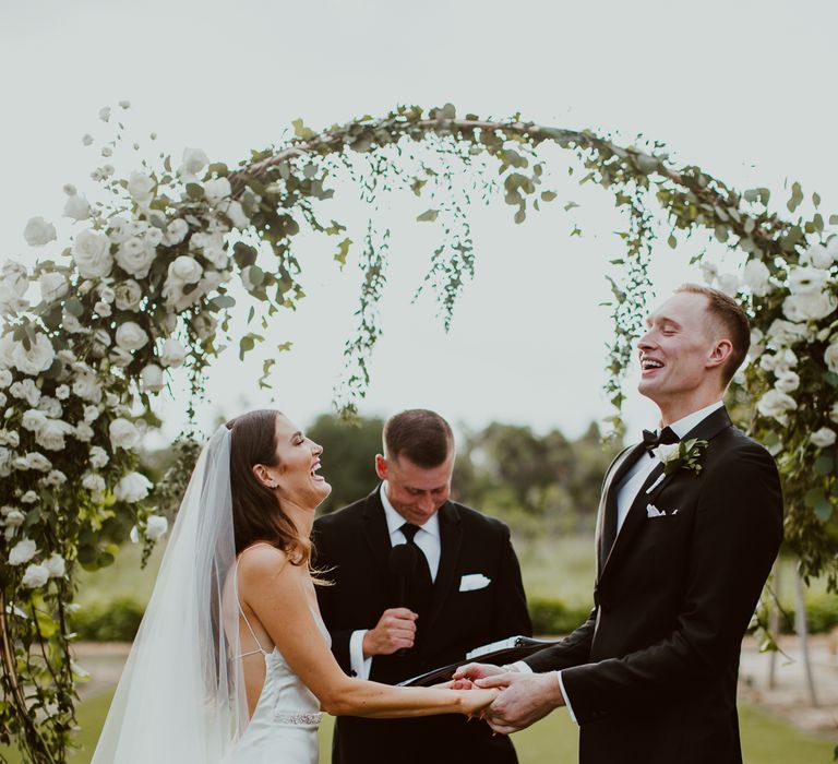 Bride and groom laugh as they get married