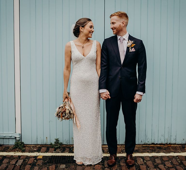 Bride and groom portrait holding hands by Victoria Somerset-How Photography