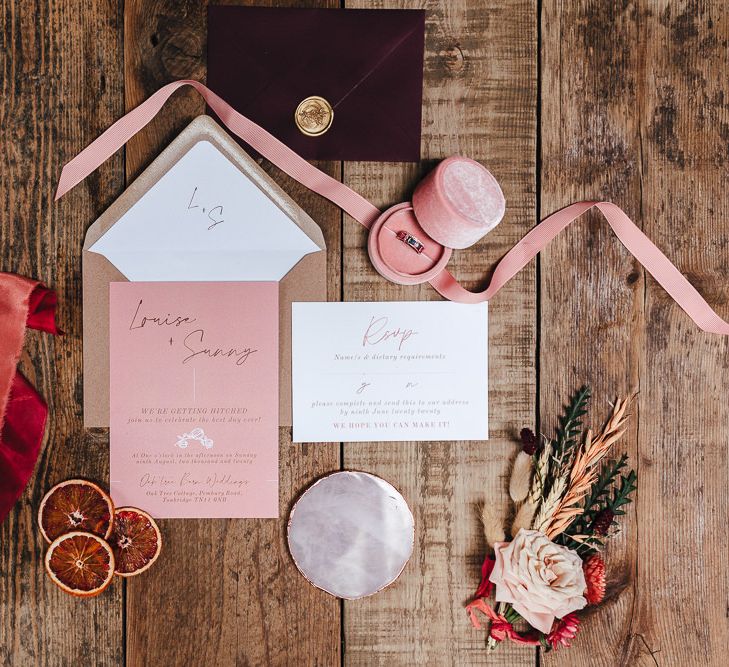 Pink stationery on rustic wooden table