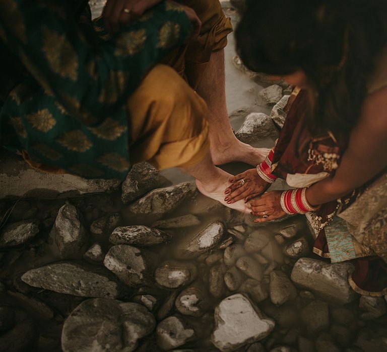 A traditional Pubjabi feet washing ritual in the lakes of Mount Cook, New Zealand