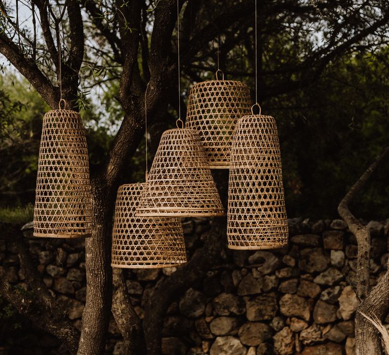 Outdoor wicker lampshades with woven bed outdoors