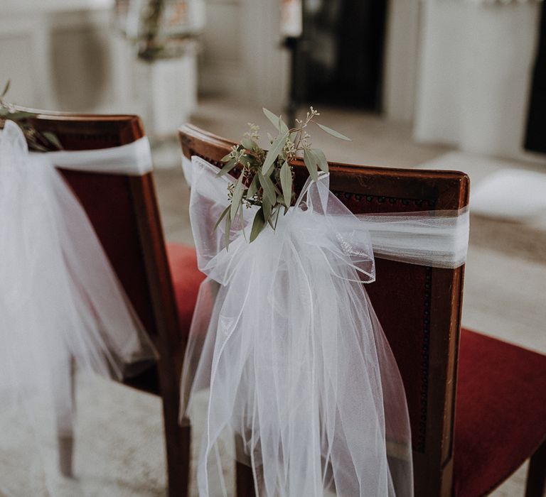 White tulle wedding chair decor with leaf details