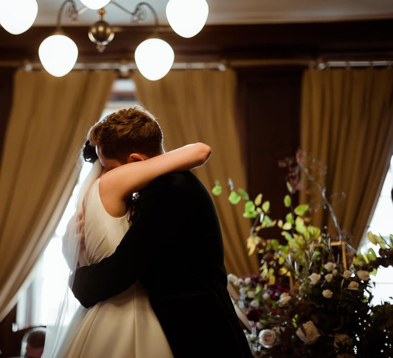 Bride and groom hugging at townhall wedding