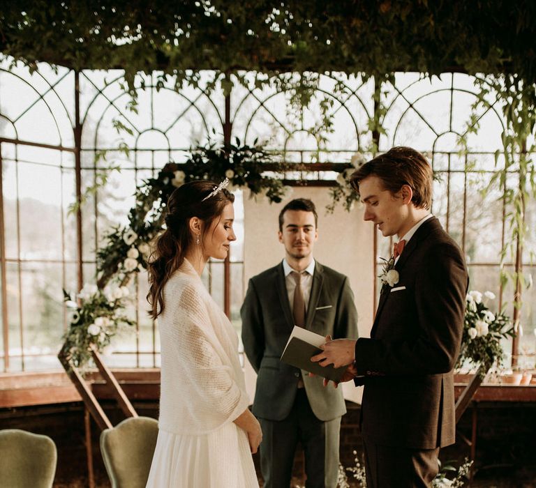 Bride and groom standing at the altar exchanging vows