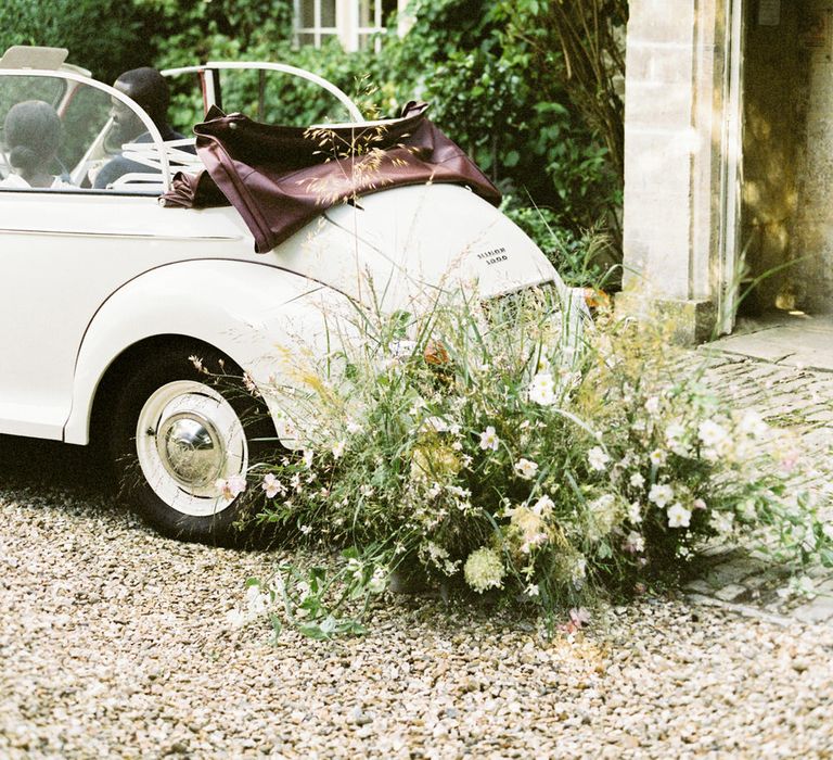 Vintage white Morris Minor car for English garden party wedding