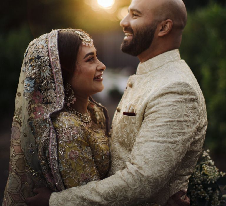 Golden hour portrait of a Bengali bride and groom 