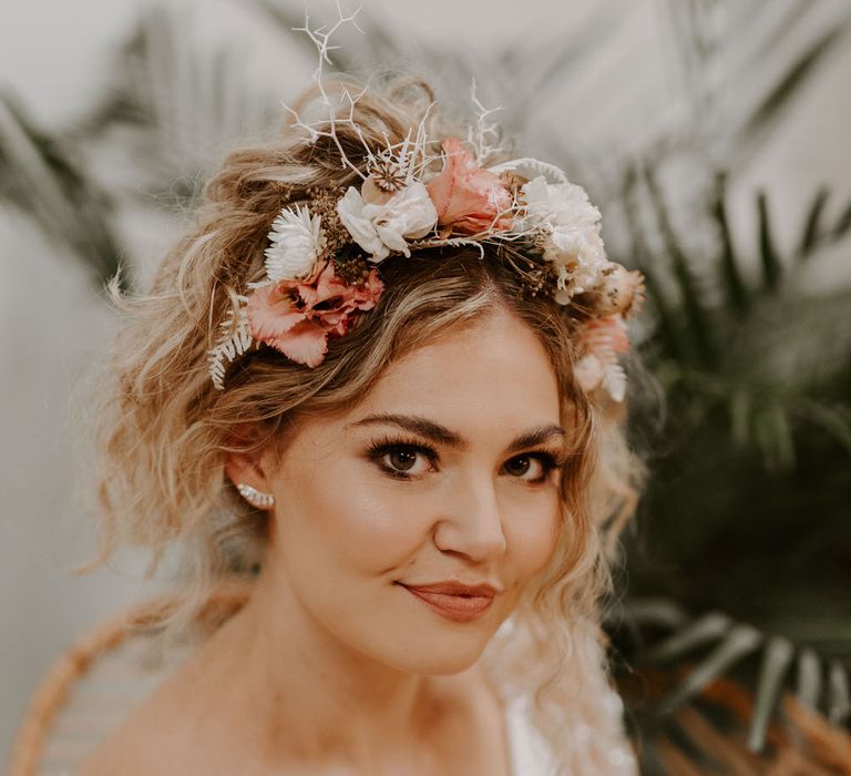 Bride with wavy beach curl wedding hair, a tropical hairband and neutral glowy makeup