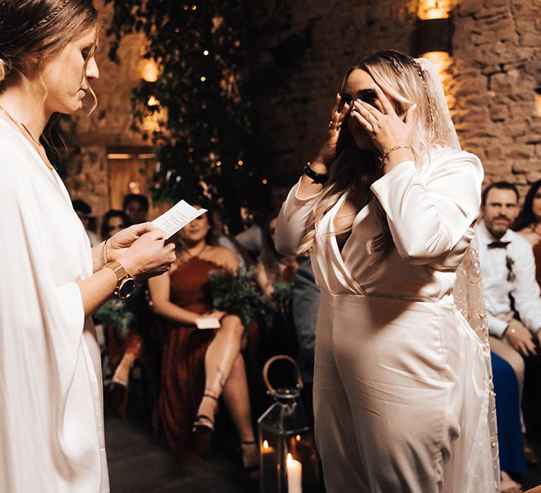 Bride becomes emotional as her wife reads wedding vows to her on their wedding day