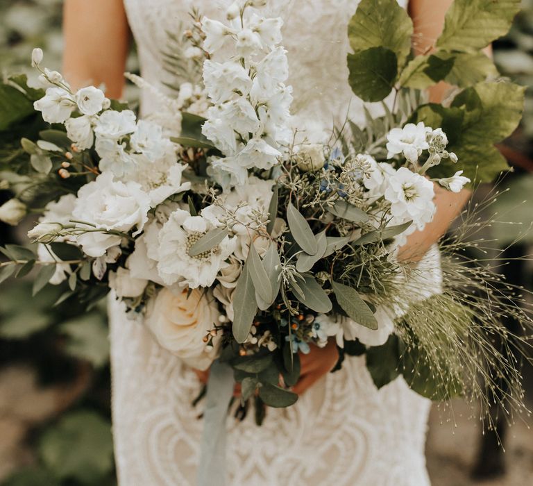 Large white flower bouquet for bride with foliage