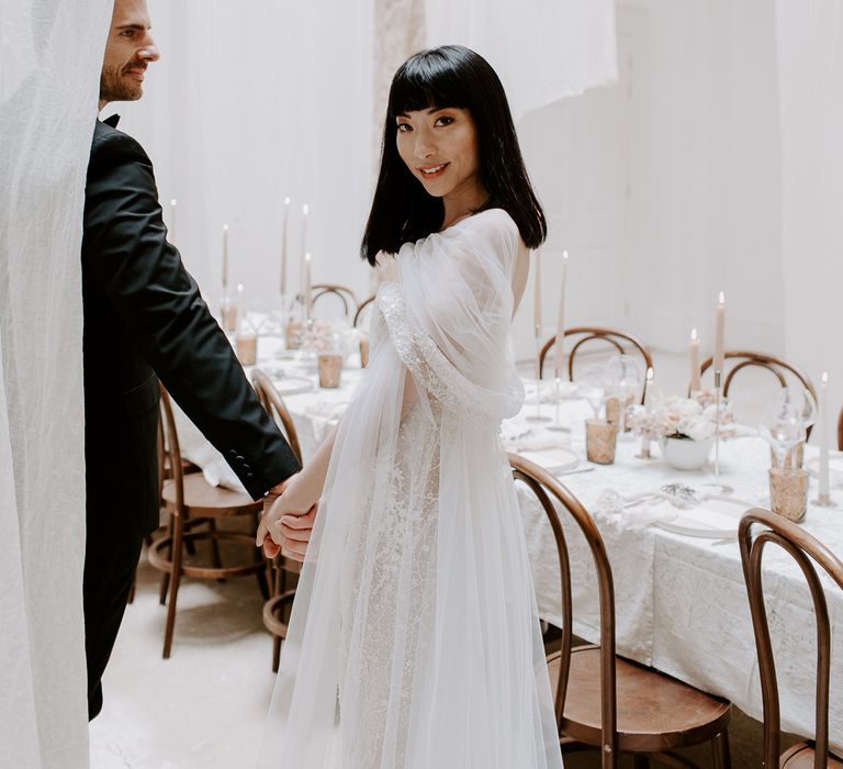 South Asian bride with shoulder length hair and a fringe wearing an embellished wedding dress with chiffon overlay 