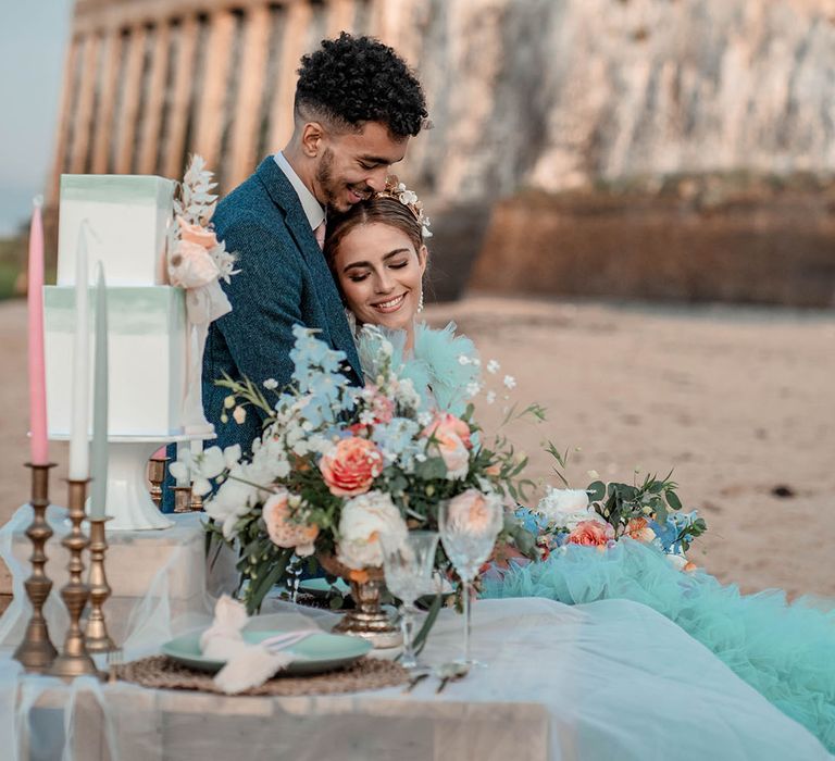 Botany Bay beach elopement in Kent with pastel coloured intimate tablescape and mint green wedding dress 