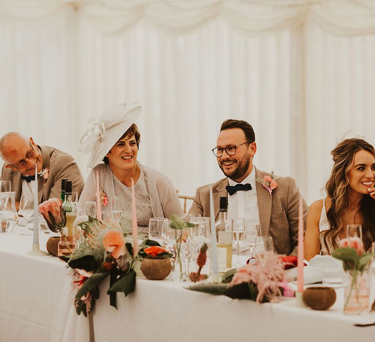 Bride & groom sit with one another on their wedding day during reception 