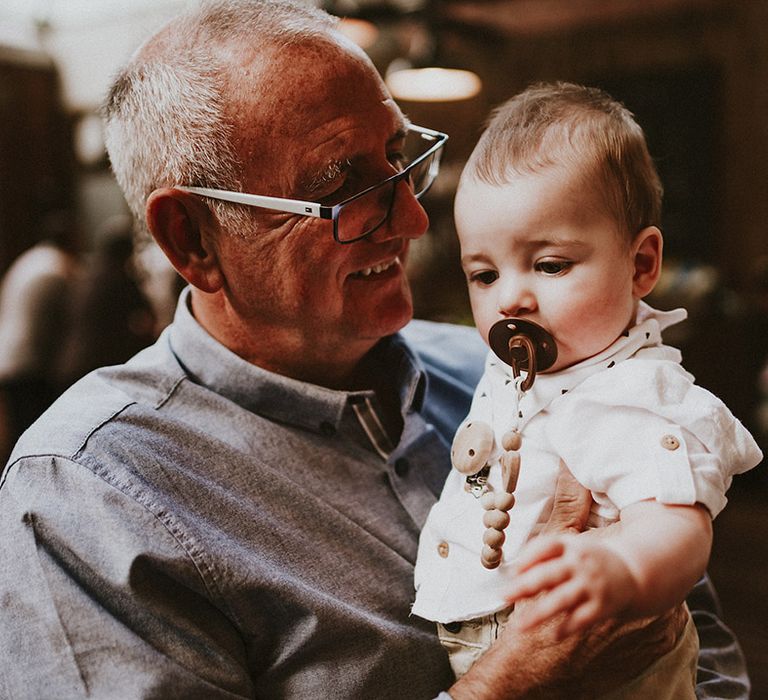 Wedding guest holds baby 