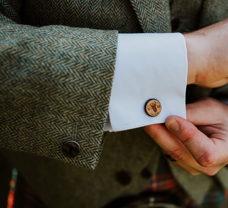 Groom applies cuffs on the morning of his wedding day