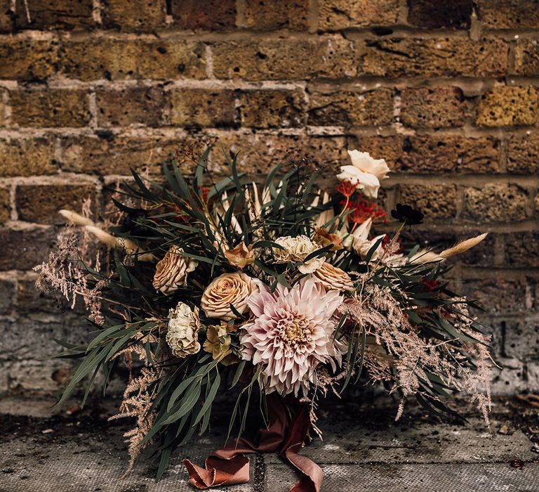 Oversized wedding bouquet with caramel and dusky pink roses, carnations, dahlias and green foliage 