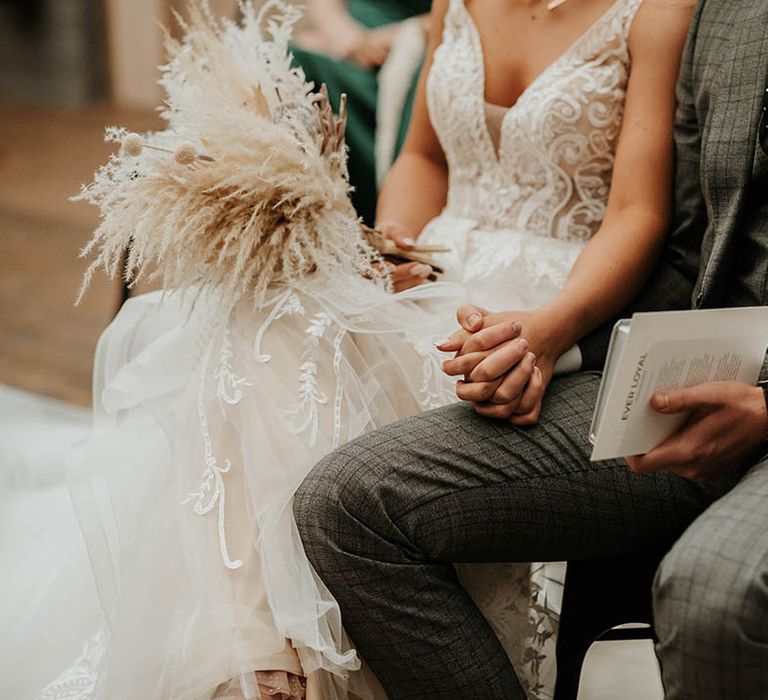 Bride clutches pampas grass bouquet