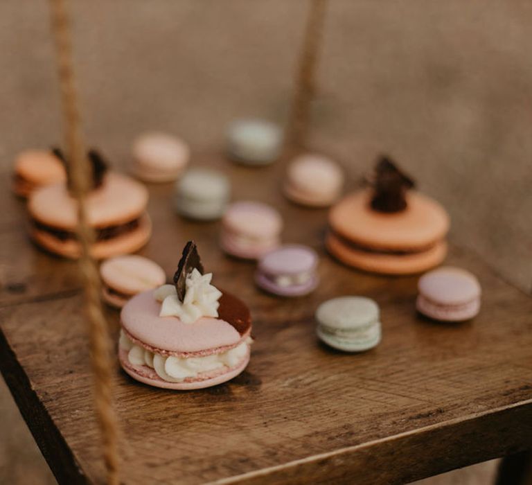 large, medium and small macaroons on a swing cake stand 