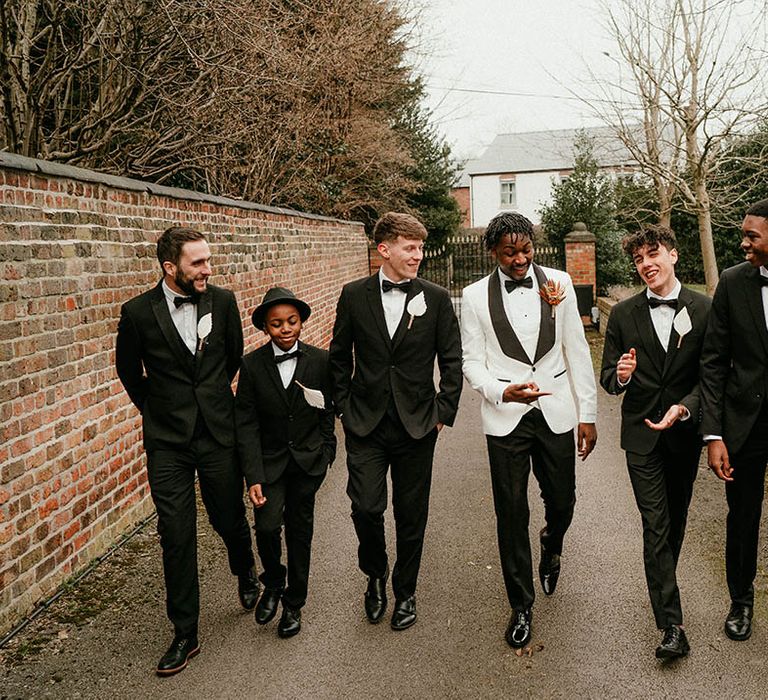 Groomsmen in matching black tuxedos