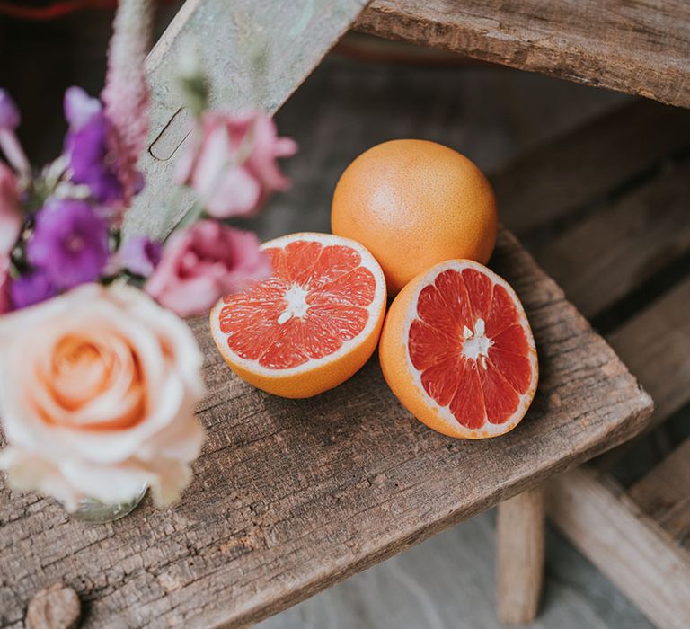 A whole and sliced grapefruit at the hydration station for wedding guests 