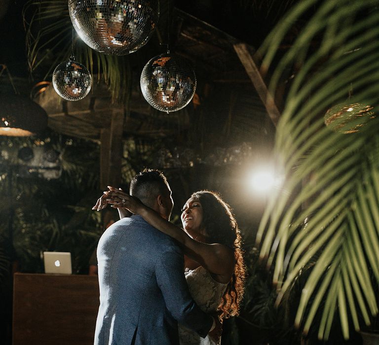 Bride and groom share their first dance in the jungle in Tulum, Mexico 